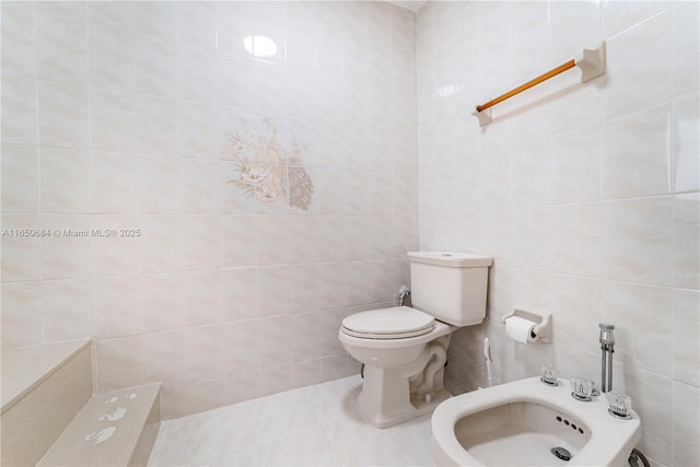 bathroom with toilet, tile patterned flooring, a bidet, and tile walls