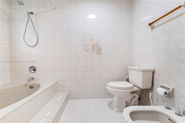 bathroom with toilet, tile patterned flooring, a bidet, and tile walls