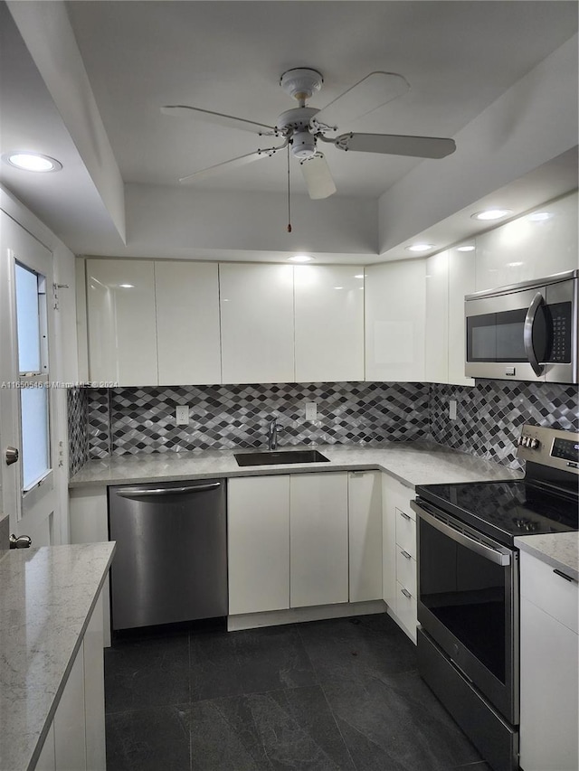 kitchen featuring white cabinets, ceiling fan, appliances with stainless steel finishes, and sink