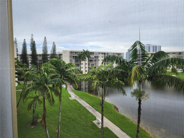 view of community featuring a water view and a yard