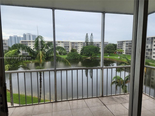 unfurnished sunroom featuring a water view