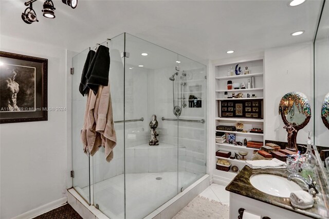 bathroom with vanity, built in features, an enclosed shower, and tile patterned floors