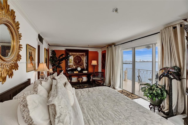 bedroom featuring ornamental molding, a water view, and access to exterior