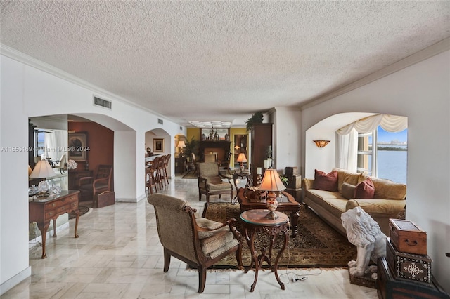 living room featuring a water view, crown molding, and a textured ceiling