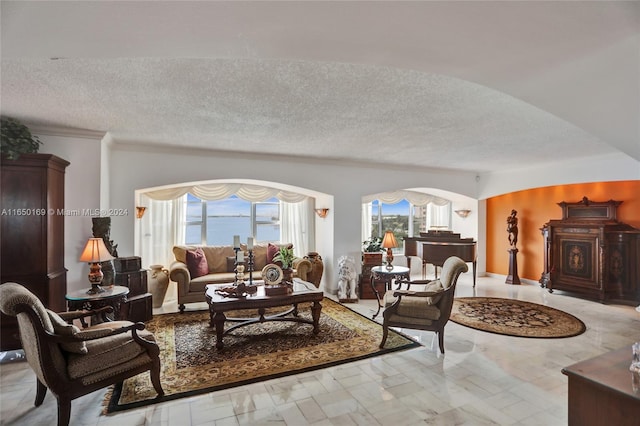 11111 Biscayne Blvd Unit 7F, Miami, FL 33181 - living room featuring arched walkways and a textured ceiling