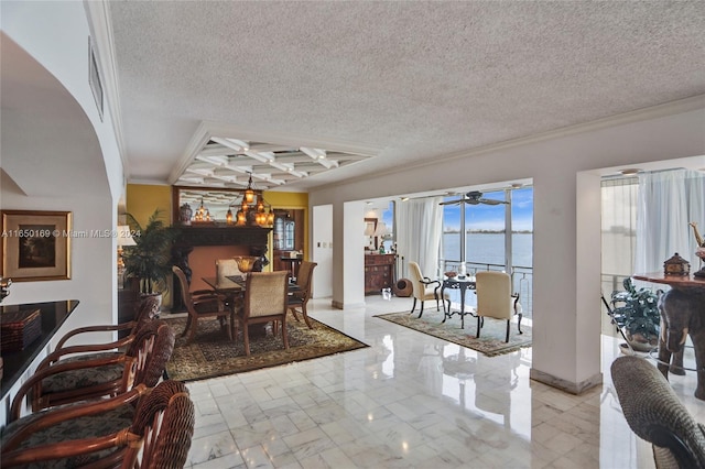 dining area featuring coffered ceiling, a water view, beamed ceiling, crown molding, and ceiling fan