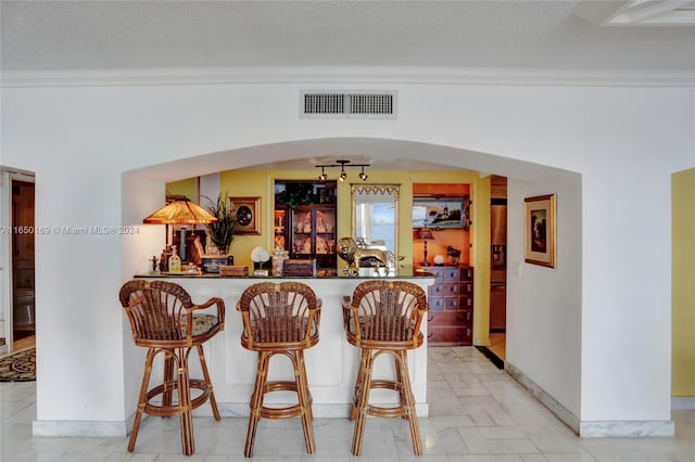 11111 Biscayne Blvd Unit 7F, Miami, FL 33181 - bar with crown molding, visible vents, bar, and arched walkways