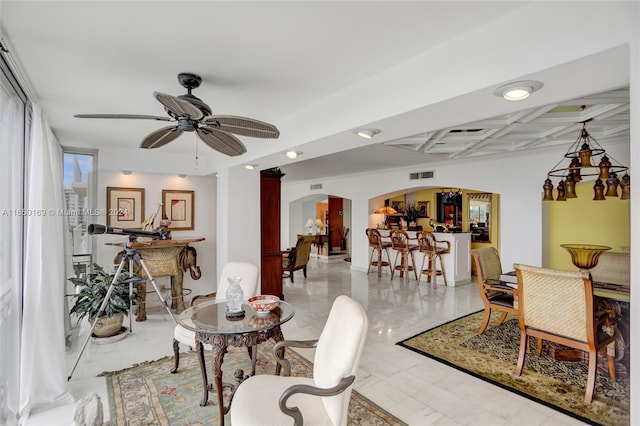 living room with coffered ceiling, ceiling fan, and beamed ceiling