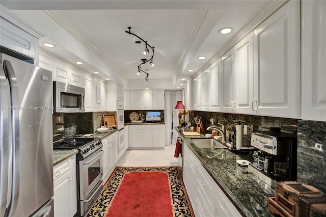 11111 Biscayne Blvd Unit 7F, Miami, FL 33181 - kitchen with ornamental molding, light tile patterned floors, white cabinetry, appliances with stainless steel finishes, and a sink