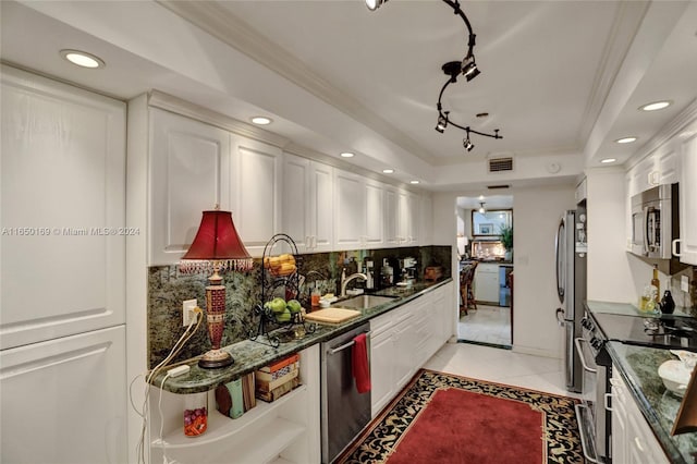 kitchen with ornamental molding, appliances with stainless steel finishes, backsplash, and white cabinets