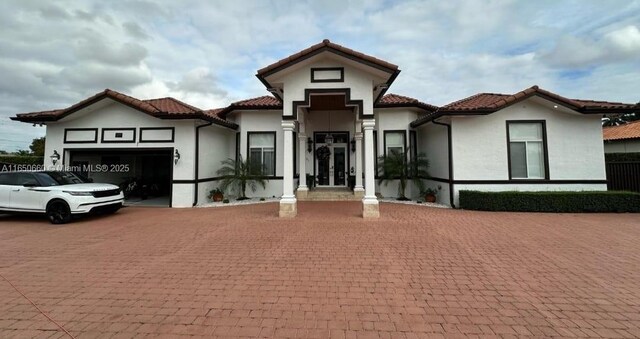 mediterranean / spanish home featuring a garage