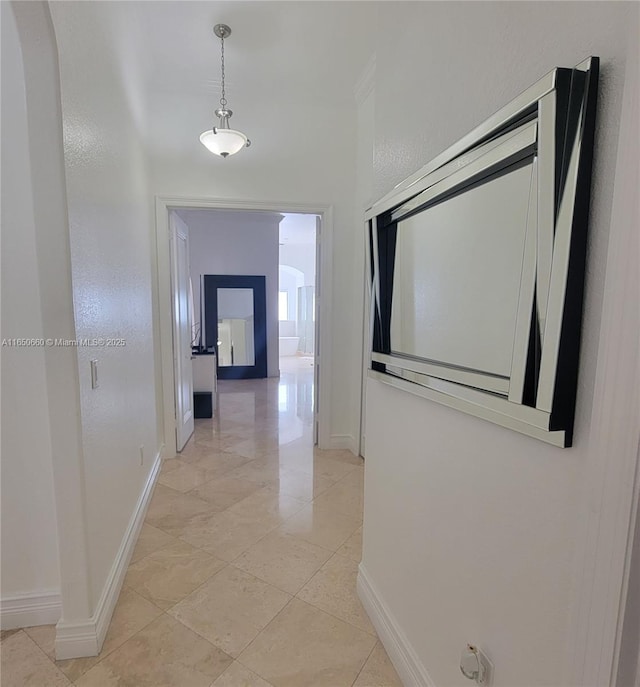 hall featuring baseboards