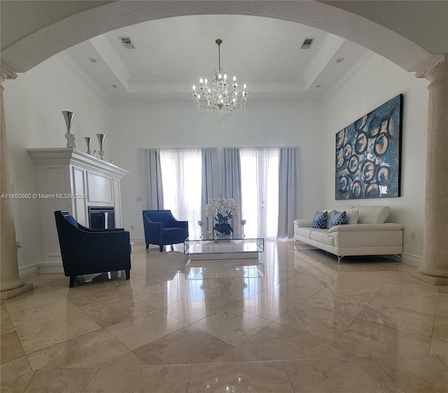 living room featuring ornamental molding, a tray ceiling, and visible vents