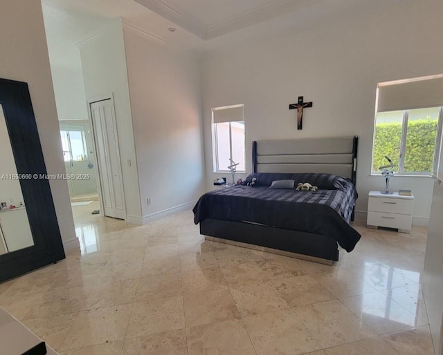 bedroom with multiple windows, crown molding, a towering ceiling, and baseboards