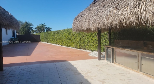 view of patio featuring beverage cooler and exterior kitchen