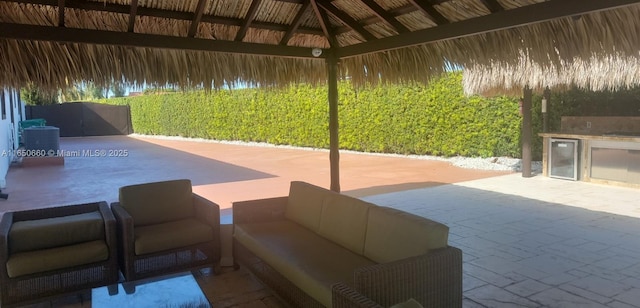 view of patio featuring a gazebo, central air condition unit, area for grilling, and an outdoor hangout area