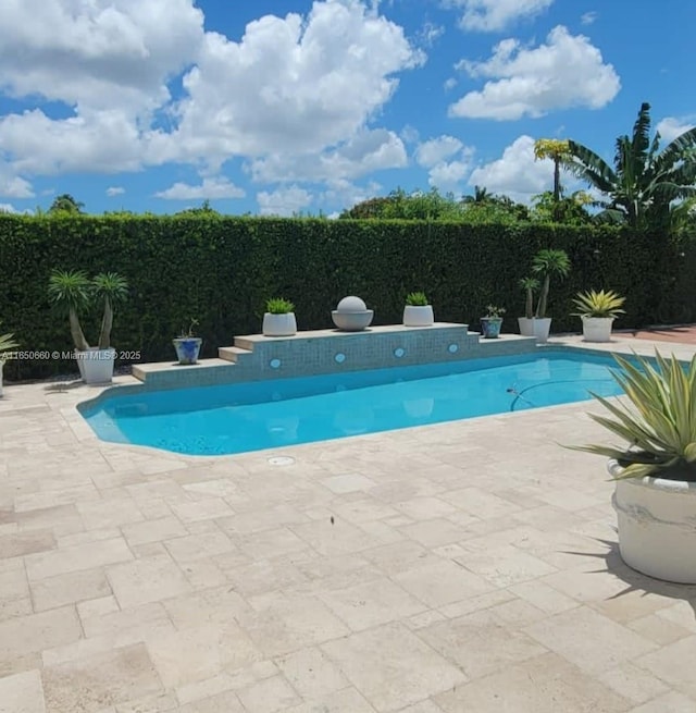 view of pool with a fenced in pool, fence, and a patio