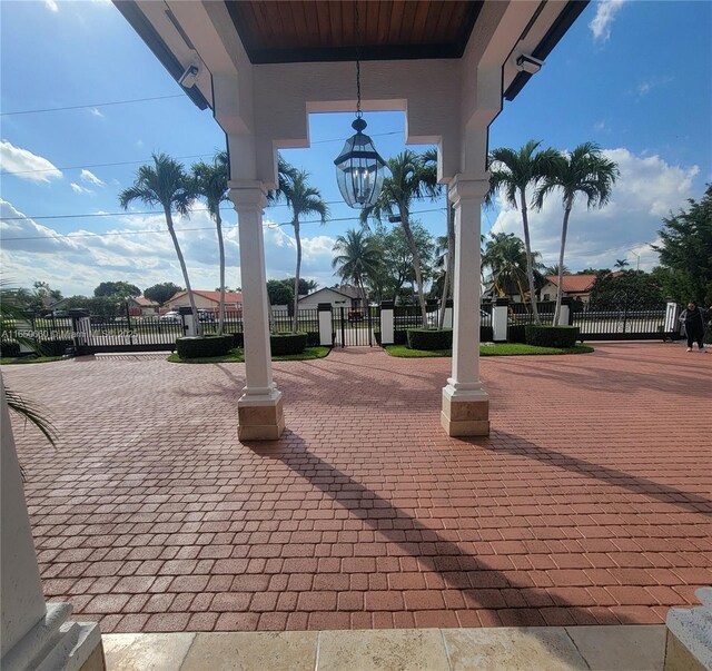 view of patio featuring fence and a gate