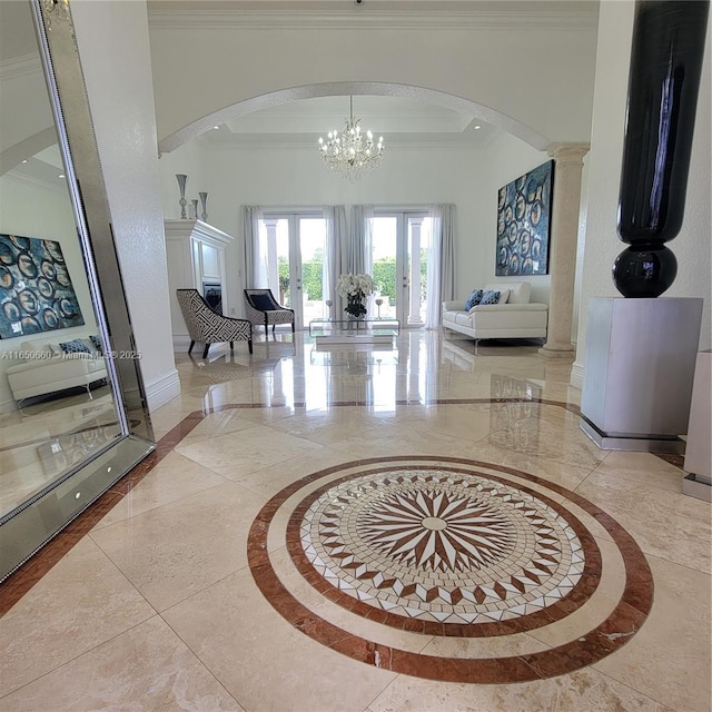 foyer featuring baseboards, arched walkways, and ornamental molding