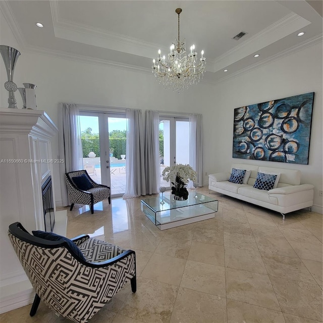 living area featuring visible vents, ornamental molding, a tray ceiling, french doors, and recessed lighting