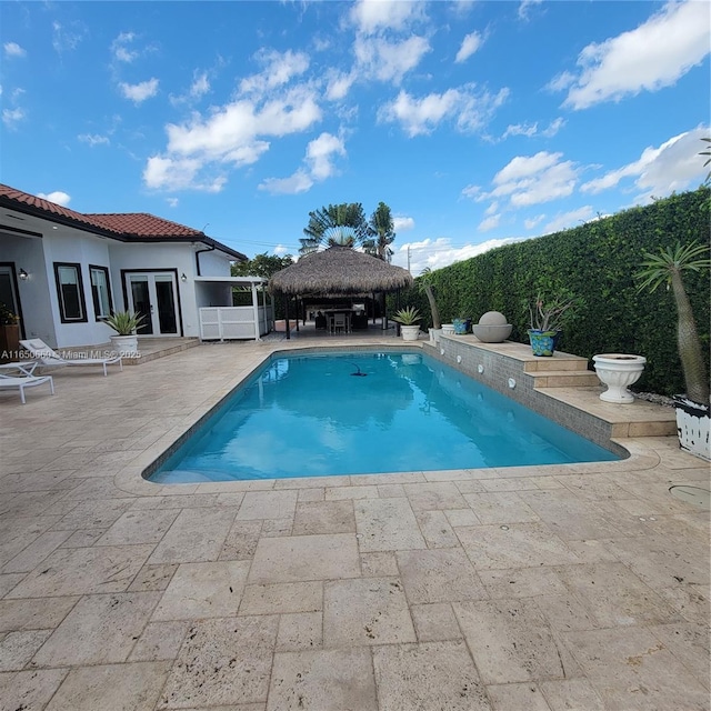 view of swimming pool with a fenced in pool, french doors, a patio, and a gazebo