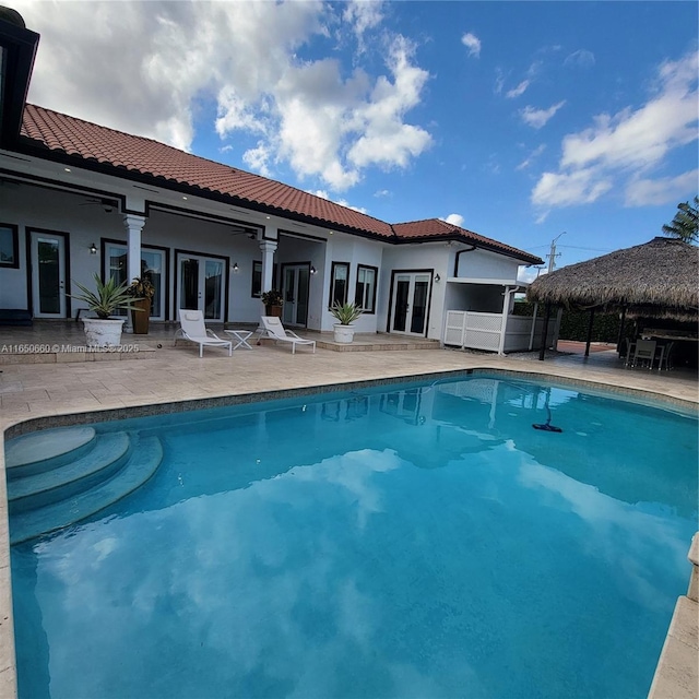 pool featuring french doors, a patio area, fence, and a gazebo