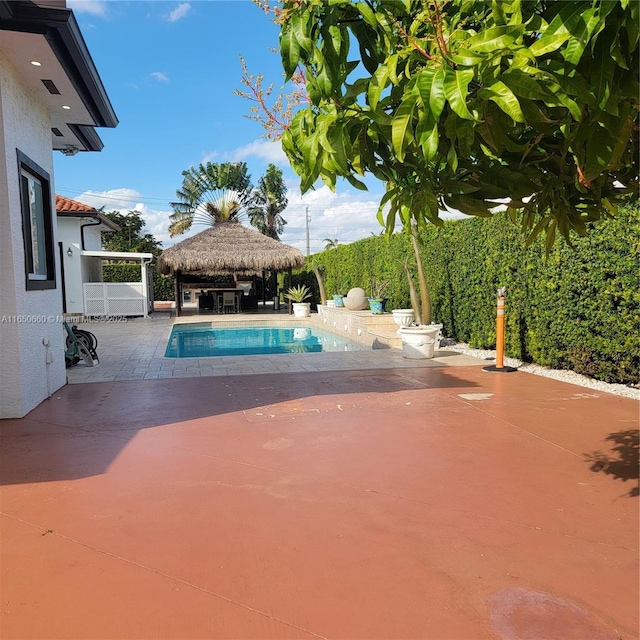 view of swimming pool with a fenced in pool, a patio, and a gazebo