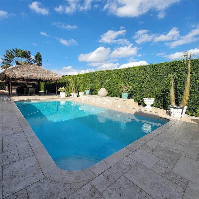 view of swimming pool with a fenced in pool, a patio area, and a gazebo