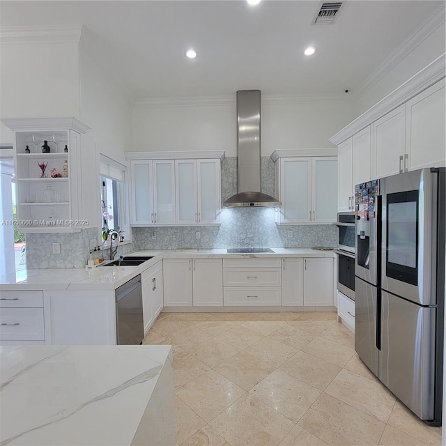 kitchen with stainless steel appliances, a sink, wall chimney range hood, and light stone countertops