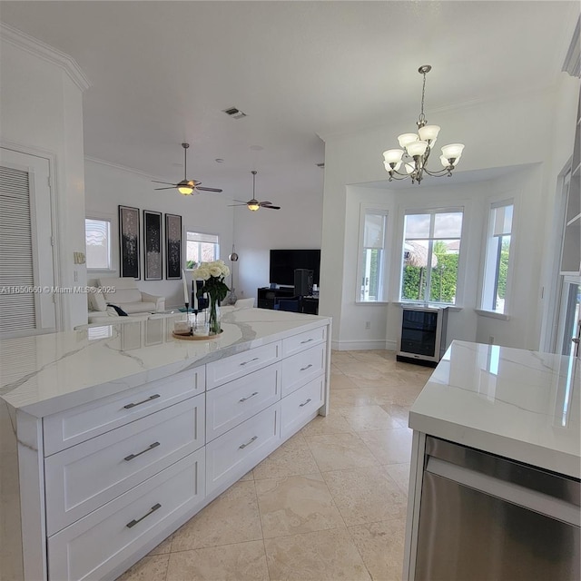 kitchen with open floor plan, light stone countertops, visible vents, and white cabinetry