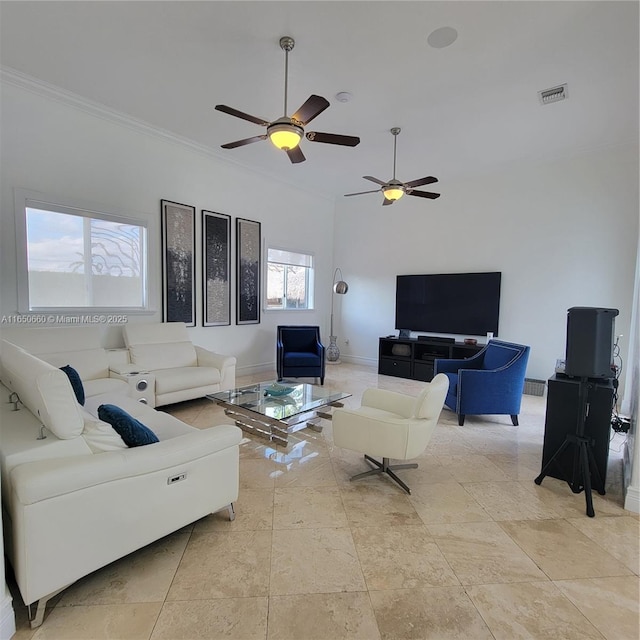 living area featuring baseboards, visible vents, and crown molding