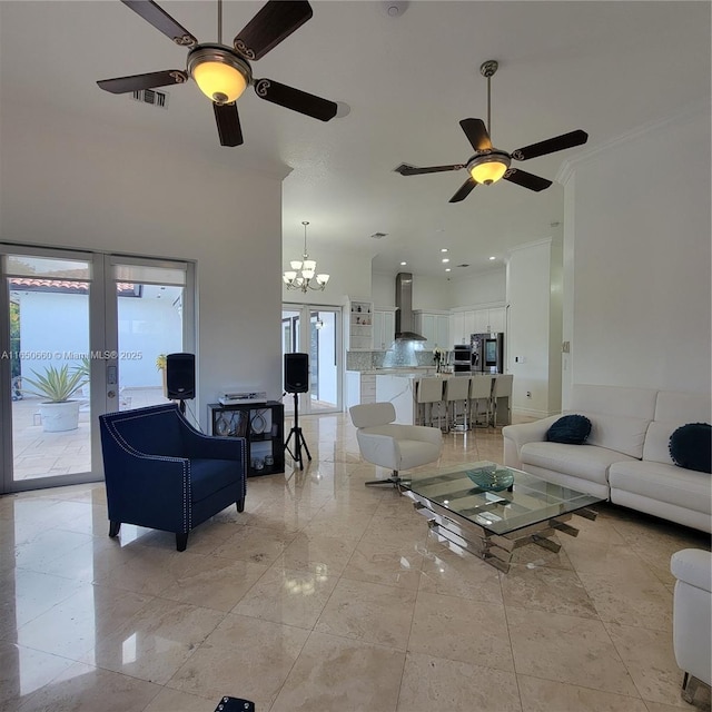 living area featuring french doors, visible vents, and an inviting chandelier