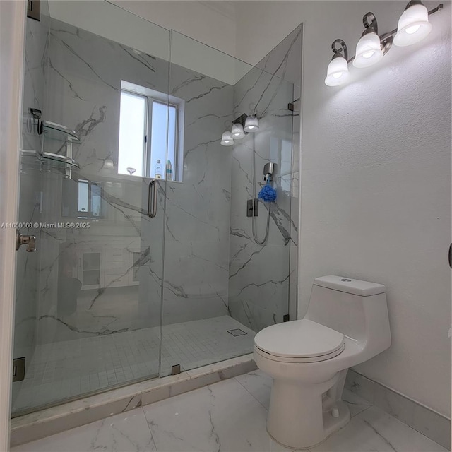 bathroom with marble finish floor, a marble finish shower, and toilet