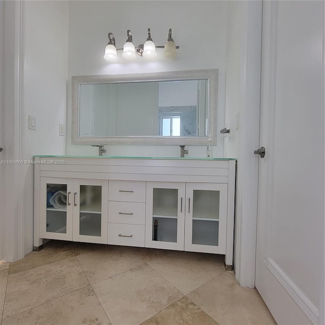 full bathroom featuring double vanity, a sink, and tile patterned floors