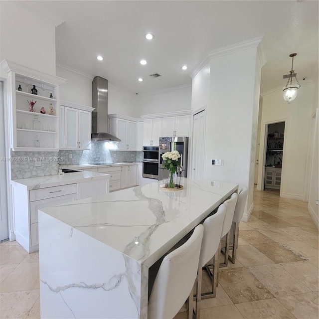 kitchen featuring open shelves, stainless steel appliances, a spacious island, decorative backsplash, and wall chimney range hood