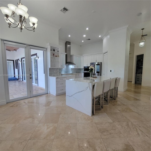 kitchen featuring visible vents, french doors, wall chimney range hood, open shelves, and backsplash