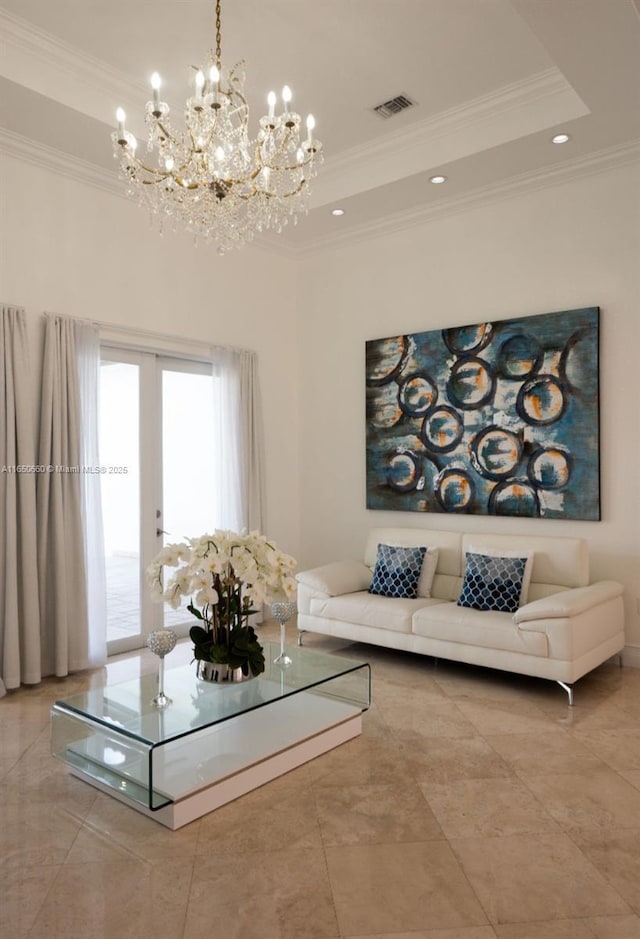 living area featuring a tray ceiling, french doors, visible vents, and crown molding