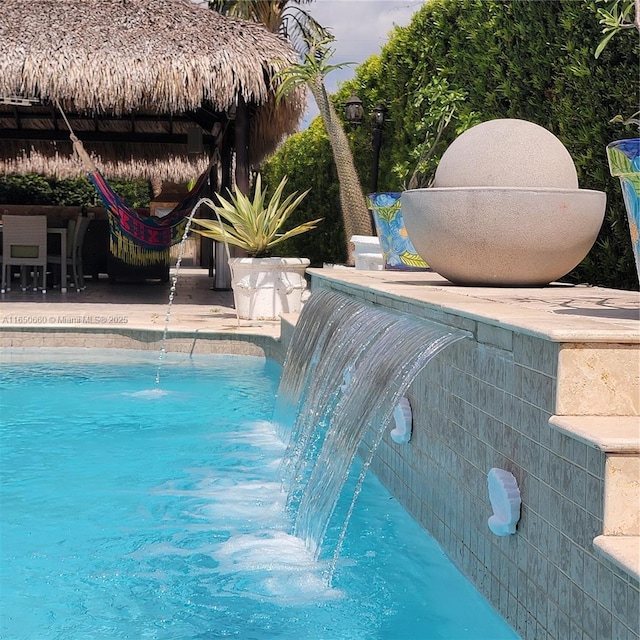 outdoor pool with a patio and a gazebo