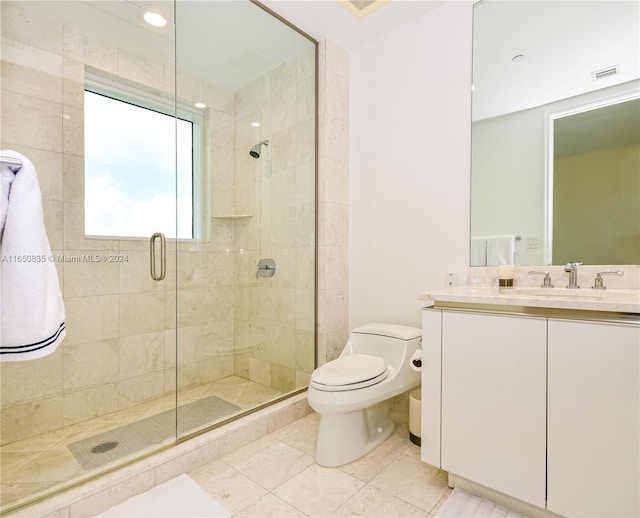 bathroom featuring vanity, toilet, and an enclosed shower