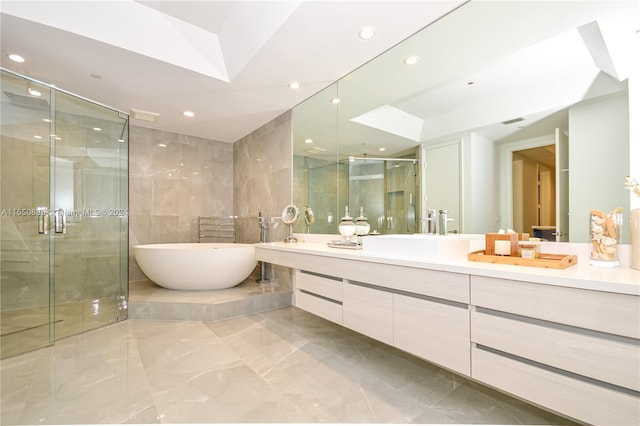 bathroom featuring independent shower and bath and vanity