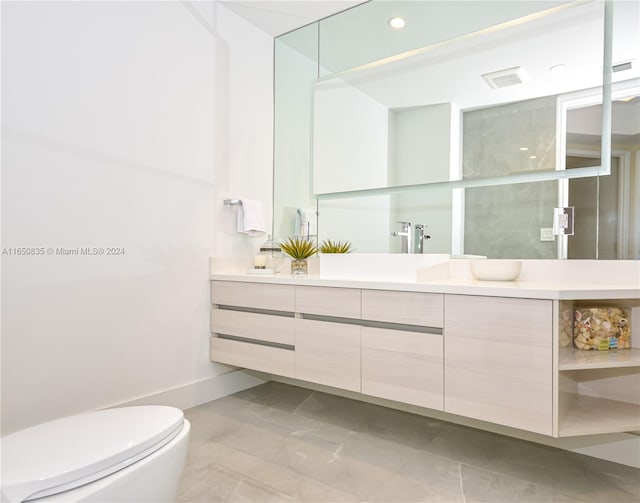 bathroom with toilet and vanity