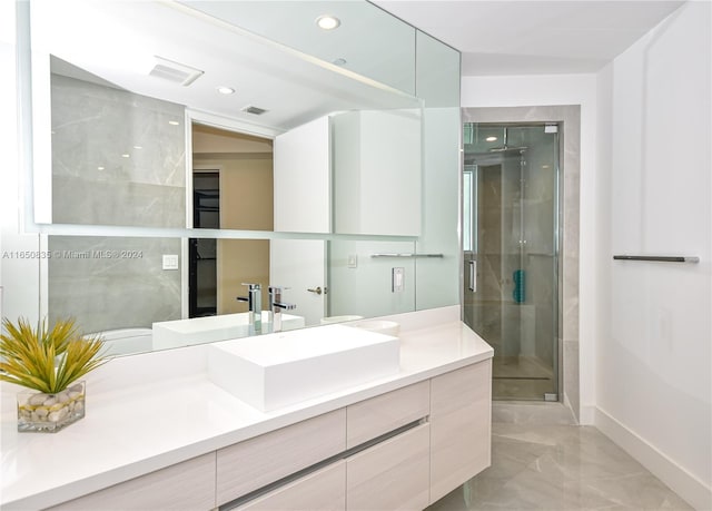 bathroom with vanity and a shower with shower door