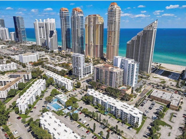 view of city with a beach view and a water view