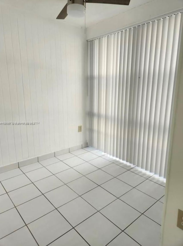 unfurnished room featuring ceiling fan and tile patterned floors