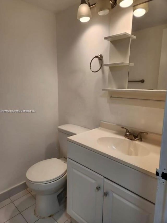 bathroom with vanity, toilet, and tile patterned floors