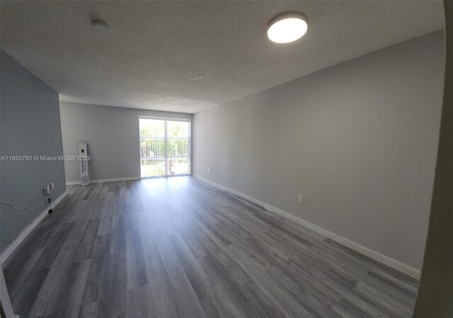 17620 Atlantic Blvd Unit 315, Sunny Isles Beach, FL 33160 - empty room featuring dark wood finished floors and a textured ceiling