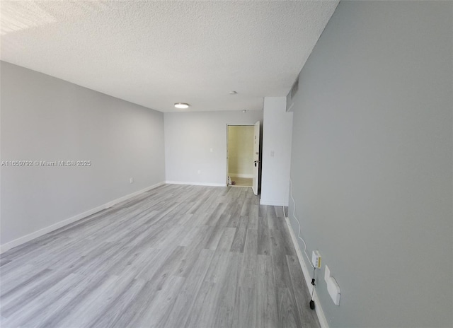 17620 Atlantic Blvd Unit 315, Sunny Isles Beach, FL 33160 - unfurnished room with light wood finished floors and a textured ceiling