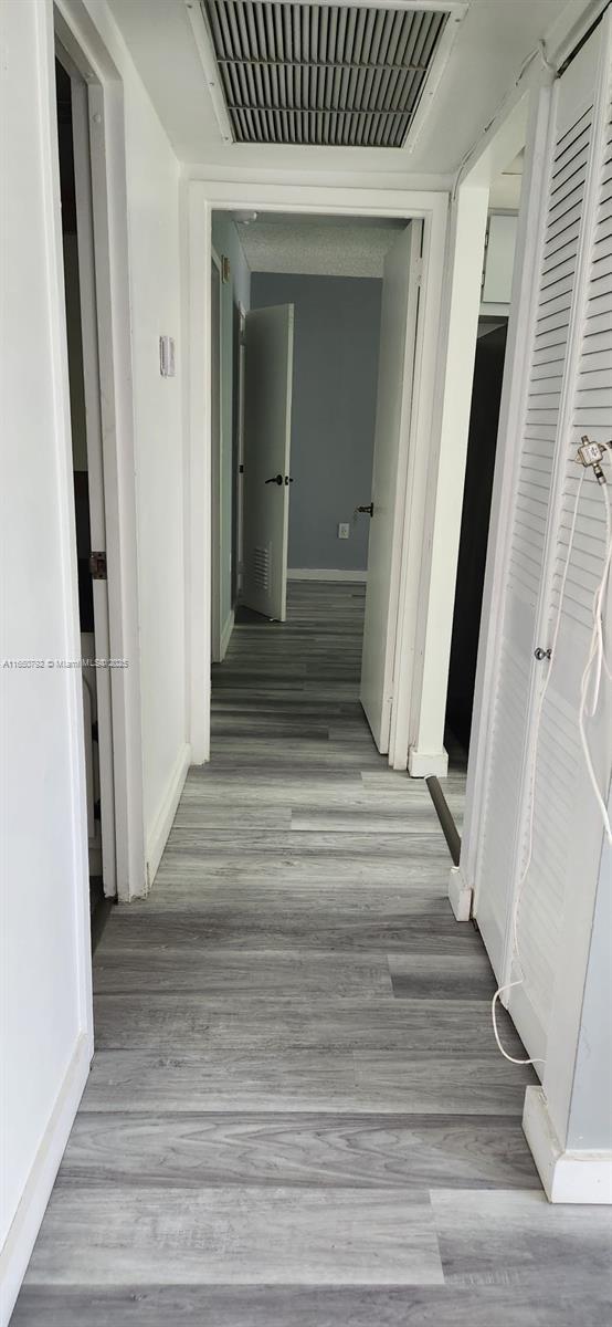 17620 Atlantic Blvd Unit 315, Sunny Isles Beach, FL 33160 - hall with baseboards and light wood finished floors