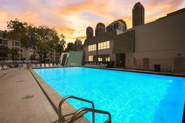 view of pool at dusk