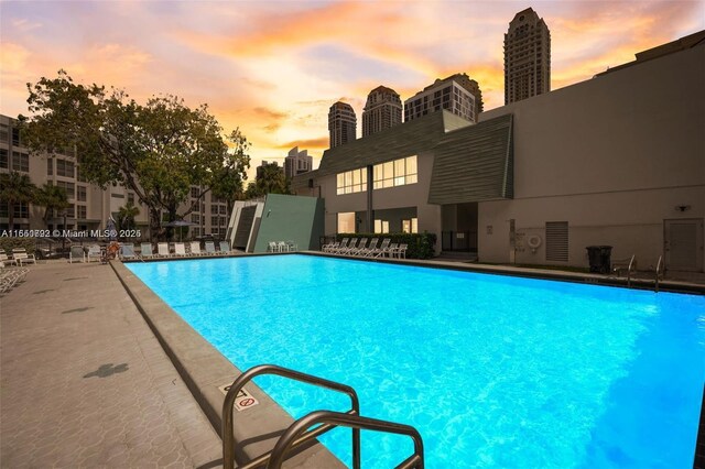 17620 Atlantic Blvd Unit 315, Sunny Isles Beach, FL 33160 - pool at dusk with a community pool and a patio area
